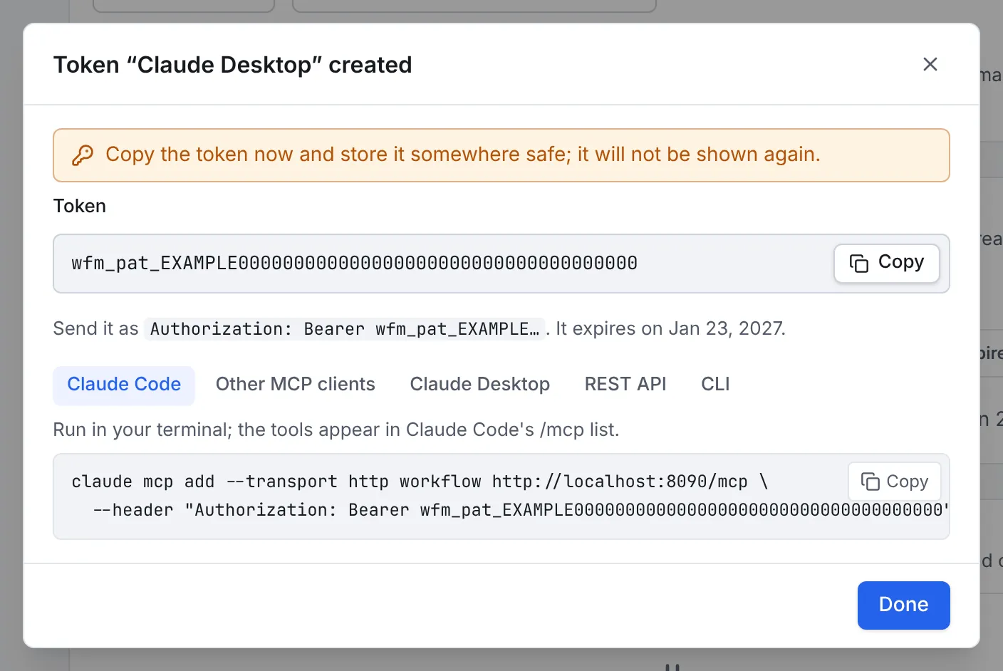 The Token Claude Desktop created dialog: a warning to copy the token now, the token itself (shown here as an example value), how to send it as a bearer token, its expiry date, and the Claude Code command with the token filled in